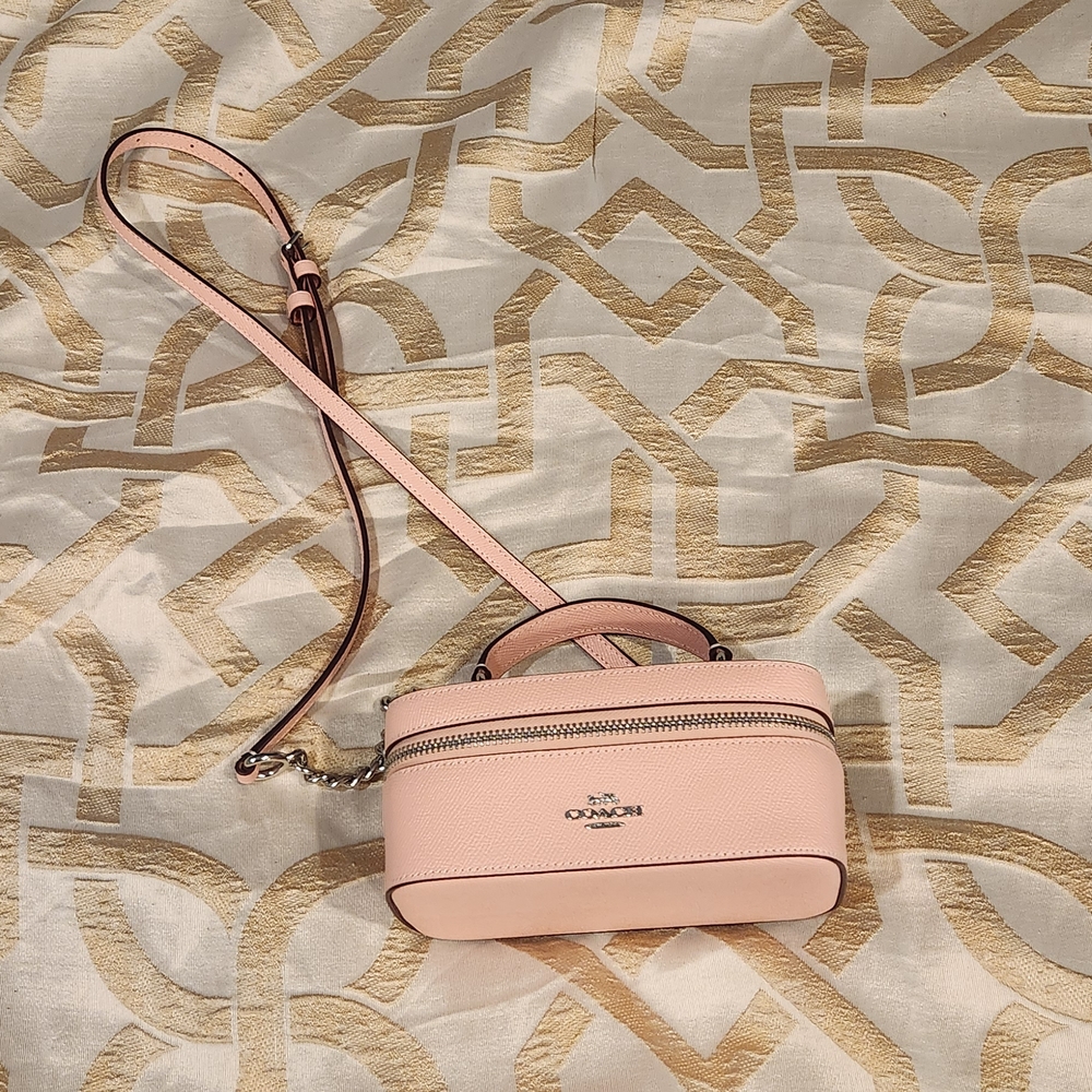 Coach Pink Crossbody Bag with Gold Accents and Structured Design